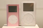 A first generation pink iPod mini (left), and a first generation iPod (right)
