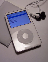 A white Fifth Generation iPod (iPod Video) with a case and earphones.