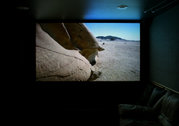 Projection screen in a home theater, displaying a high-definition television image.