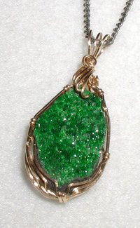 Pendant in uvarovite, a rare bright-green garnet. The long dimension is 2 cm (0.8 inch)