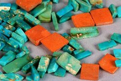 A selection of Ancestral Puebloan (Anasazi) turquoise and orange argillite inlay pieces from Chaco Canyon (dated ca. 1020–1140 CE) show the typical colour range and mottling of American turquoise.