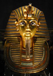 The iconic gold burial mask of Tutankhamun, inlaid with turquoise, lapis lazuli, carnelian and coloured glass.