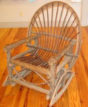 This unusual rocking chair is made of rough wood to give it a rustic look.