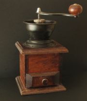 An old-fashioned manual coffee grinder.