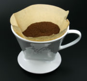 Water seeps through the coffee and is then collected to a container.