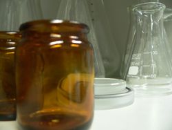 Brown glass jars with some clear lab glassware in the background