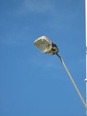 A Sylvania high pressure sodium vapor street lamp from Australia. The brown circular object under the light is a photocell.