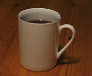 A white glazed ceramic mug