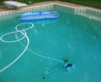 Below ground, outdoor pool. Automated pool cleaner visible at bottom.