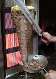 A vertical rotisserie cooking Shawerma