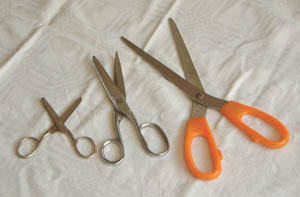 Different types of scissors - sewing (left), paper (middle), kitchen (right)