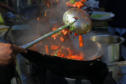 Cooking in a wok with a hauk