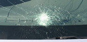 Automobile windshield displaying "spiderweb" cracking typical of laminated safety glass.