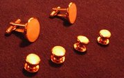 This set of cuff links and studs features pearl inlays.