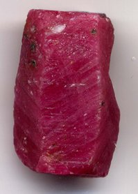 Ruby crystal before faceting, length 0.8 inches (2 cm).