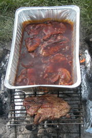 The St. Louis barbecue style of preparation involves slow open grilling until done, then simmering in a pan of barbecue sauce that is placed on the grill.