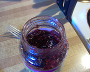 An open jar of raspberry jam