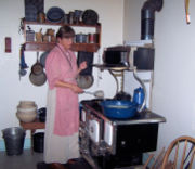 A park interpreter demonstrates a typical rural American kitchen of 1918 at The Sauer-Beckmann Farmstead, a living history farm in Texas.