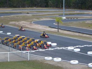 Kart racers race each other on a outdoor track