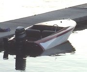 A 1962 "Rebel". A wooden speedboat with an outboard engine.